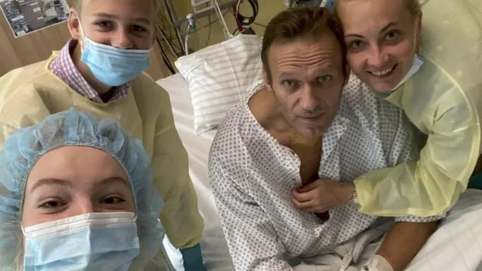 纳瓦尔尼（Alexeï Navalny）躺在医院病床上，与妻子和孩子们在一起。