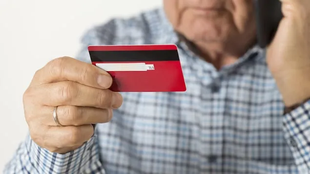一个男人拿着信用卡。